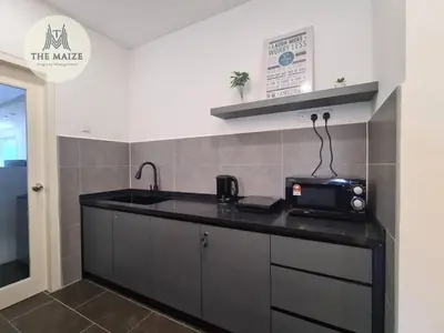 a kitchen with a sink and a microwave on a counter at The Cove Hillside Residence Ipoh - Elegance Parisian in Ipoh