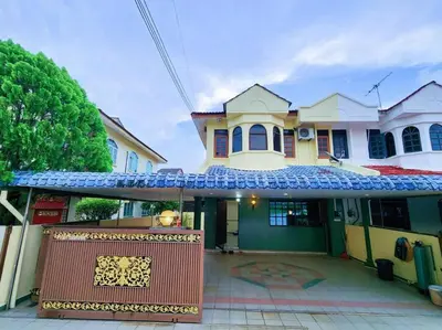 a house with a gate in front of it at Pengkalan 42 Double-Storey Homestay in Kampong Pinji