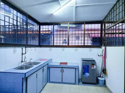 a kitchen with blue counters and a sink and windows at Pengkalan 42 Double-Storey Homestay in Kampong Pinji