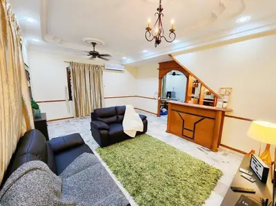 a living room with a couch and a table at Pengkalan 42 Double-Storey Homestay in Kampong Pinji