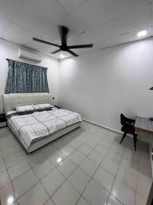 a bedroom with a bed and a ceiling fan at raub homesty in Kampong Sempalit Hilir