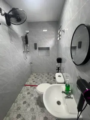 a bathroom with a sink and a toilet and a mirror at raub homesty in Kampong Sempalit Hilir