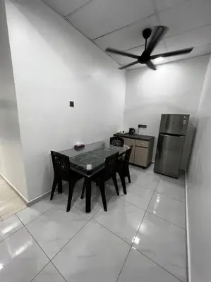 a kitchen with a table and a ceiling fan at raub homesty in Kampong Sempalit Hilir