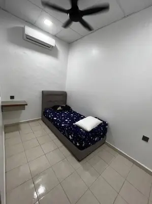 a bed in a room with a ceiling fan at raub homesty in Kampong Sempalit Hilir