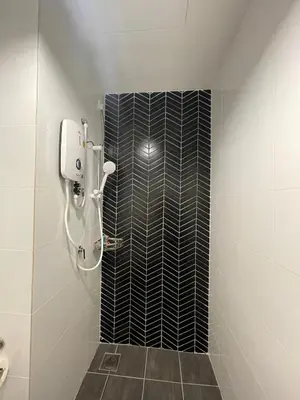 a bathroom with a shower with a black and white tile wall at The Horizon Ipoh 3BR ORCHID - by Goswell in Ipoh