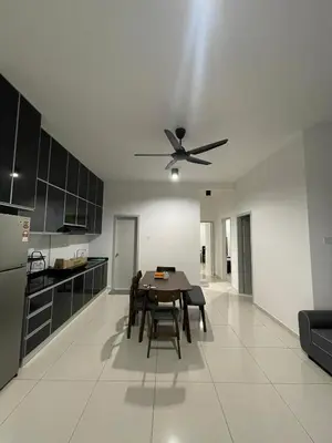a kitchen with a table and a ceiling fan at The Horizon Ipoh 3BR ORCHID - by Goswell in Ipoh