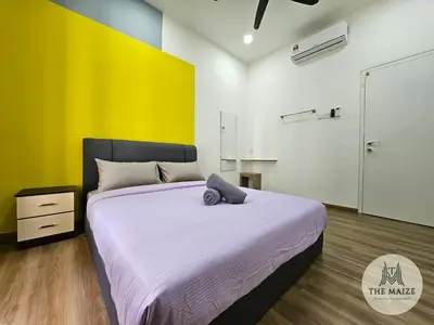 a bedroom with a large bed with a yellow wall at The Cove Hillside Residence Ipoh - Tranquility Vibes in Ipoh