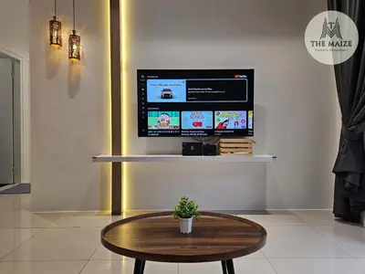a room with a table and a tv on a wall at The Cove Hillside Residence Ipoh - Tranquility Vibes in Ipoh