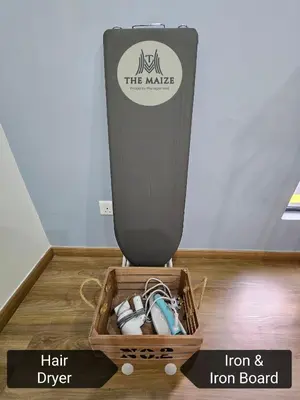 a wooden crate with a box of hair drier and iron board at The Cove Hillside Residence Ipoh - Tranquility Vibes in Ipoh