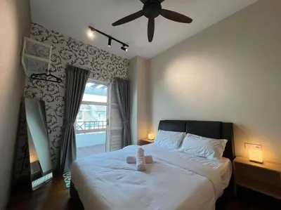 a bedroom with a bed with a teddy bear on it at Karpal Singh Drive Seaside Georgetown 4BR-15pax by 3C in George Town