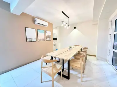 a dining room with a wooden table and chairs at Karpal Singh Drive Seaside Georgetown 4BR-15pax by 3C in George Town