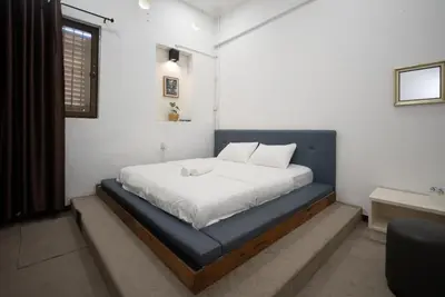 a bedroom with a bed with a blue bed frame at Moustachz Hauze , Georgetown in George Town