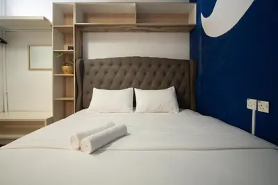 a bed with two pillows on top of it at Moustachz Hauze , Georgetown in George Town