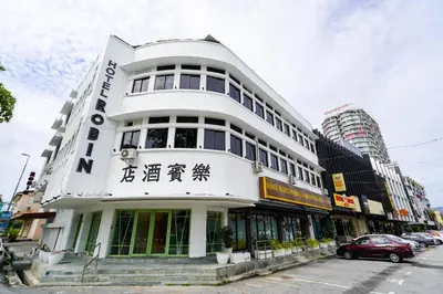 a white building with writing on the side of it at Robin Hotel in Ipoh