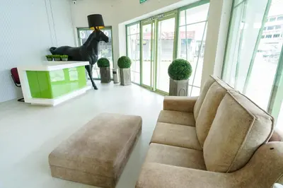 a living room with a chair and a horse statue at Robin Hotel in Ipoh