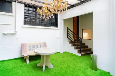 a room with a table and a bench and a chandelier at Robin Hotel in Ipoh
