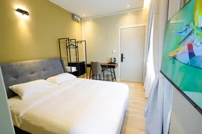 a bedroom with a bed and a television in it at Robin Hotel in Ipoh