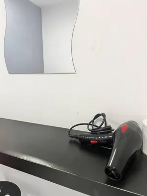 a black hairbrush sitting on a counter in front of a mirror at LIly Brava 7 in Tanah Rata