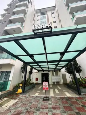 a building with a glass canopy in front of it at LIly Brava 7 in Tanah Rata