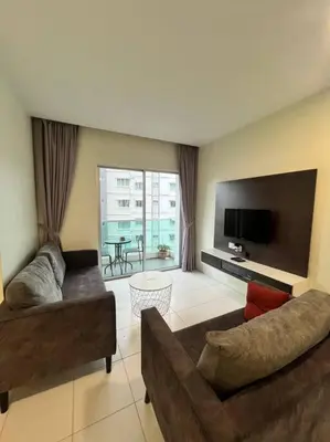 a living room with two couches and a flat screen tv at Lily Brava 5 in Tanah Rata