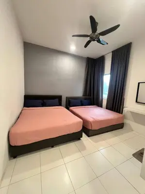 a bedroom with two beds and a ceiling fan at Lily Brava 5 in Tanah Rata