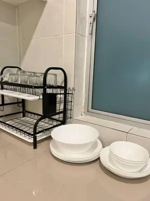 three white plates sitting on a counter in a bathroom at Lily Brava 5 in Tanah Rata
