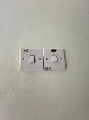a lightswitch on a wall in a room at Lily Brava 5 in Tanah Rata