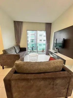 a living room with a couch and a tv at Lily Brava 5 in Tanah Rata