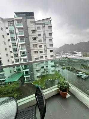 a balcony with a view of a river and buildings at Lily Brava 5 in Tanah Rata