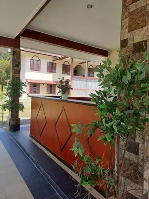 a porch with a wooden fence in front of a building at Lemuni Retreat & Training Centre - Kerling, Selangor in Kerling