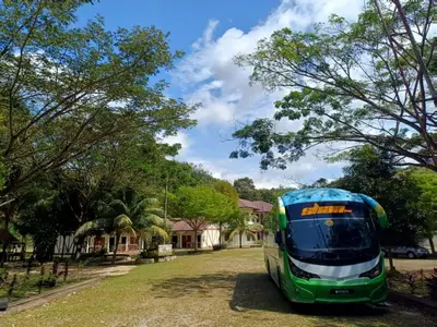 a green and blue bus parked in a yard at Lemuni Retreat & Training Centre - Kerling, Selangor in Kerling