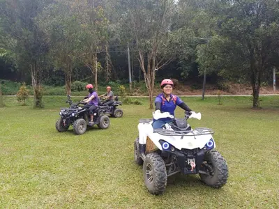 a group of people on atvs in a field at Lemuni Retreat & Training Centre - Kerling, Selangor in Kerling