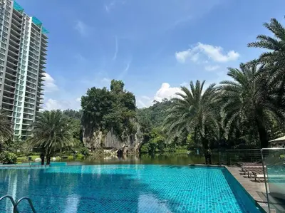 a swimming pool in a resort with a rock formation at Ipoh lakeside Suite Ipoh 4pax in Ipoh