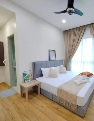 a bedroom with a large bed with a ceiling fan at Ipoh lakeside Suite Ipoh 4pax in Ipoh