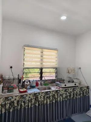 a kitchen with a sink and a window at Bougainvillea Garden KKB in Kuala Kubu Baharu