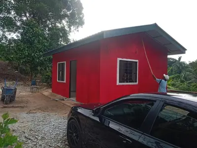 a red house with a cat on the roof of a car at Renovate on progress in Kuala Kubu Baharu