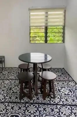 a table and stools in a room with a window at Renovate on progress in Kuala Kubu Baharu