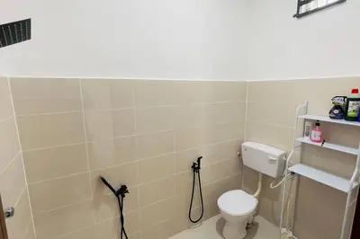 a bathroom with a white toilet in a room at Rumah Kita HStay BM view Self check in 2Room in Kubang Semang