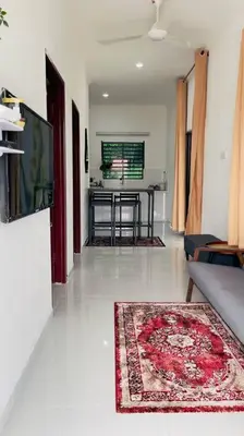 a living room with a couch and a table at Rumah Kita HStay BM view Self check in 2Room in Kubang Semang