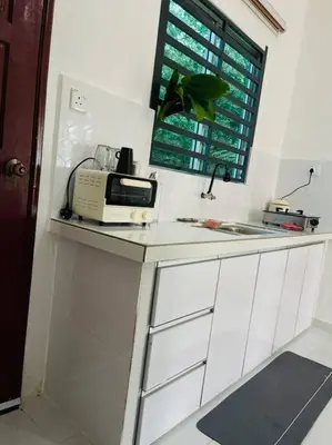 a kitchen with a sink and a microwave on a counter at Rumah Kita HStay BM view Self check in 2Room in Kubang Semang