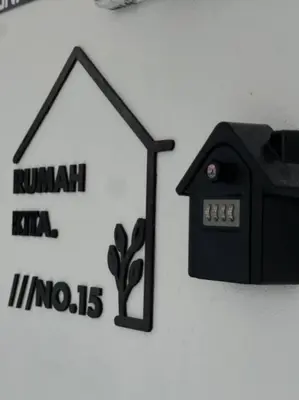a wall with a house and a clock on it at Rumah Kita HStay BM view Self check in 2Room in Kubang Semang