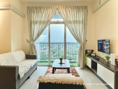 a living room with a couch and a large window at Kampung Paloh Residence Ipoh with 2 Parking & Free Netflix in Ipoh