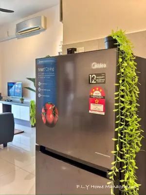 a refrigerator with an apple on it in a room at Kampung Paloh Residence Ipoh with 2 Parking & Free Netflix in Ipoh