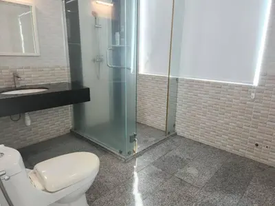 a bathroom with a shower and a toilet and a sink at Ipoh Kinta river front luxury pent house 4br 18pax in Ipoh