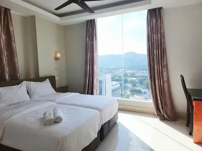 a hotel room with a bed with a large window at Ipoh Kinta river front luxury pent house 4br 18pax in Ipoh