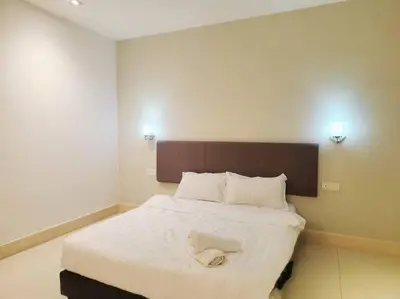 a bedroom with a bed with a towel on it at Ipoh Kinta river front luxury pent house 4br 18pax in Ipoh