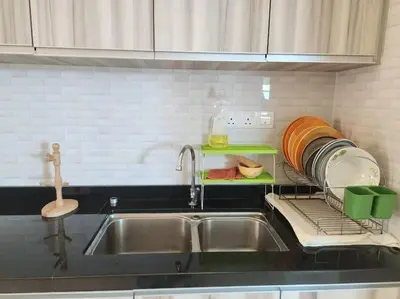 a kitchen sink with a drying rack next to it at Ipoh Kinta river front luxury pent house 4br 18pax in Ipoh