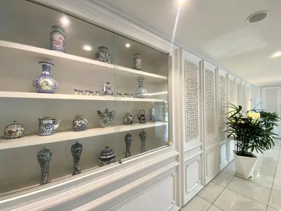 a room with shelves filled with blue and white vases at Hotel 19, Penang in George Town