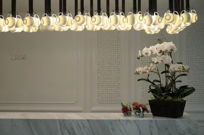 a chandelier above a table with a vase of flowers at Hotel 19, Penang in George Town