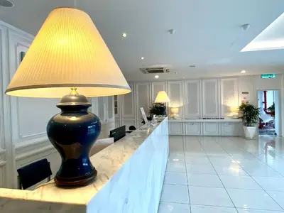 a large lobby with a table with a lamp on it at Hotel 19, Penang in George Town